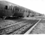 A long row of passenger train cars in India, during WWII.  In the CBI.