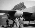 12th Air Service Group men pose in revetment with B-25 in Guangxi, before a karst peak. During WWII.