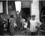 A Chinese women in the midst of daily life during war-time, in Yunnan province, China, most likely around the Luliang air base area.