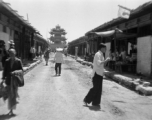 A drum or bell tower at the center crossroads of a squared, walled town in northern China, during WWII.