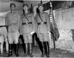 Young Nationalist officers stand before banners for different regiments of the 48th Army Division at rally.