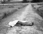 "Yunnan (China), shrouded corpse of houseboy executed for theft." During WWII in SW China. 