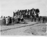 Chaplain Dwayne H. Mengel conducts a temporary military burial in Yunnan, China.  The 308th took heavy casualties, and one of the Chaplain's duties included burying recovered bodies in local graves until they could be repatriated after the war.