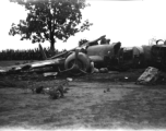 Wrecked B-25 Mitchell bomber on the ground in the CBI. The wreck was apparently at an air base, and probably on take-off, as the craft is sprayed with fire-retardant foam, and bombs are scattered about the wreck site. During WWII.