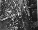 Bombing of small riverside town likely in SW China (esp. Guangxi), but possibly in Burma, or French Indochina. During WWII. Signs of previous bombings are visible about, including destroyed houses along the main road, and bomb craters here and there.