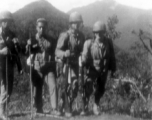American GIs (and possibly Chinese soldier or interpreter) on mountains near Baoshan, Yunnan, China, during WWII, during battle with Japanese forces.