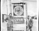 Mechanics pose with 373rd Bombardment Squadron HQ sign, presumably at Luliang air base, Yunnan, China. During WWII.