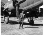 Photographer Edward Harold Dixon standing before a C-47 at a base in China, during WWII.