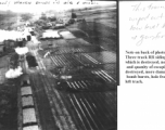 This train was wiped out with low level bombs & gunfire. Note on back of the photo reads: Three track RR siding with 17 cars and locomotive, which is destroyed, note wreckage from bomb bursts and quantity of escaping steam. 3 cars probably destroyed, more damaged.  Two of track torn up by bomb bursts, hole from strafing is visible on extreme left track.
