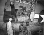 Chinese workers unloading barrels from a C-46 transport during WWII.