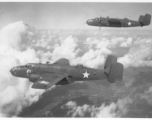 B-25s of the 22nd Bombardment Squadron in flight over wet plains in SW China or Burma during WWII.
