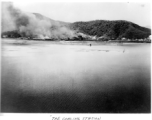 The coaling station at Campha Port, French Indochina, is left burning after bombing raid by B-25s.  22nd Bombardment Squadron.