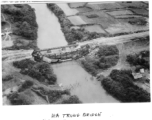 Bomb railroad bridge in French Indochina (Vietnam), during WWII. Note train engine on its side in water, and rebuilt temporary bridge nearby.  22nd Bombardment Squadron, 2nd Group.