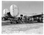 Loading film into 24th Mapping Squadron F-7A, #441678, from photographic equipment carrying trailer. February 22, 1945.
