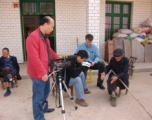 Mr. SU, and Mr. LUCAS interview old timers in the village.  This home is only a few meters from the pond where the remains rest.  Mr. HUANG Xiling video tapes.