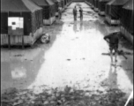 Tent city of flooded living quarters at Liangshan. Stream next to the site has overflowed in this image. During WWII.