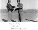 Col. Richard Wise (left) receives the prize--a spittoon "Piss-pot" at a horse race arranged at Guilin during WWII.