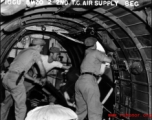 Men inside a US transport plane drop supplies from the air.10CU 6M20 2ND T.C. AIR SUPPLY SEC.