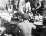 Chinese civilians eat a nice meal in the CBI during WWII.