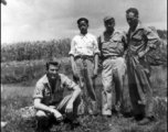 Left to right: Unknown, houseboy, Robert Zolbe, and unknown pose in front of corn field in the CBI. During WWII.