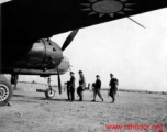 Chinese and American officers prepare for a mission on a B-25J at an unidentified base. Their Squadron (unknown) is part of the 1st Bombardment Group, Chinese-American Composite Wing (CACW).