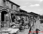 Local people in a village in Yunnan province, China: A quiet market street near Kunming on a non-market day. During WWII.