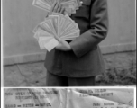 Pfc Eugene Riede holds a large collection of Chinese currency, in China, during WWII.