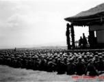Chinese soldiers sit on ground listening to speech during exercises in southern China, probably Yunnan province, or possibly in Burma.