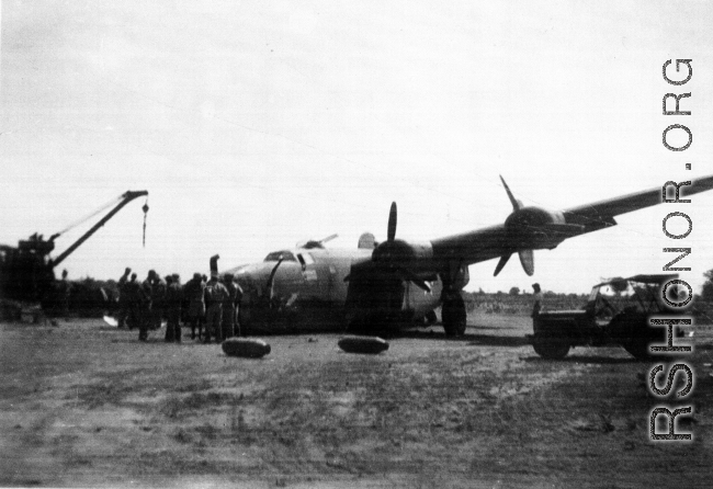 Broken B-24 "WE'REWOLVES", crashed on take-off crash on March 20th, at Panagarh. Upon crash, live bombs were spewed out of the bomb bay. Fortunately the arming pins were still in the fuses. Speculation of some was that the accident was caused by loss of lift due to the negative angle of attack caused by a high speed take-off. The crashed was observed by Majore W. A. Delahay and Capt. T. E. Sledge who had been beside the runway observing 492nd Bomber Squadron planes take of on the mission.