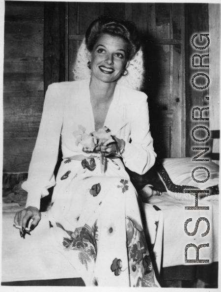 Celebrities visit and perform at Yangkai, Yunnan province, during WWII: Ann Sheridan smokes a cigarette from the edge of her bed at Yangkai.