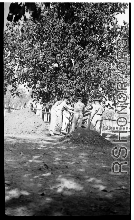 Solemn burial ceremony for American GIS who had died at a temporary war-time graveyard. In the CBI, during WWII.