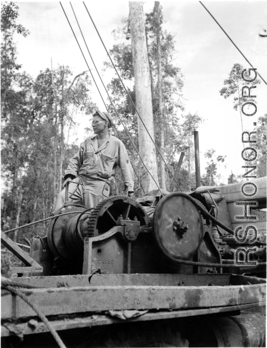 GIs moving logs using spar tree in Burma.  During WWII.  797th Engineer Forestry Company.