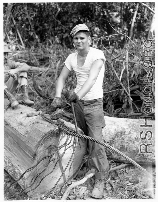 Engineer of the 797th Engineer Forestry Company in Burma, weaving a pulling eye in cable.  During WWII.