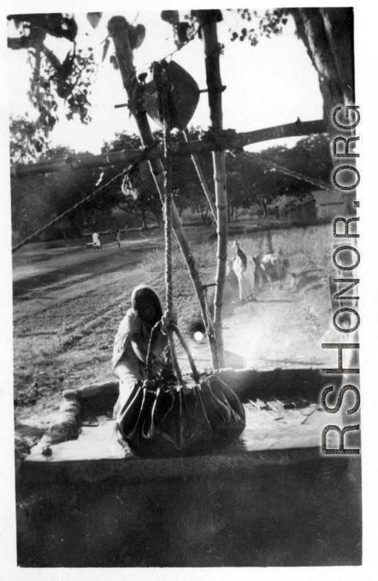 Local people in Burma near the 797th Engineer Forestry Company--A woman gets water in Burma.  During WWII.