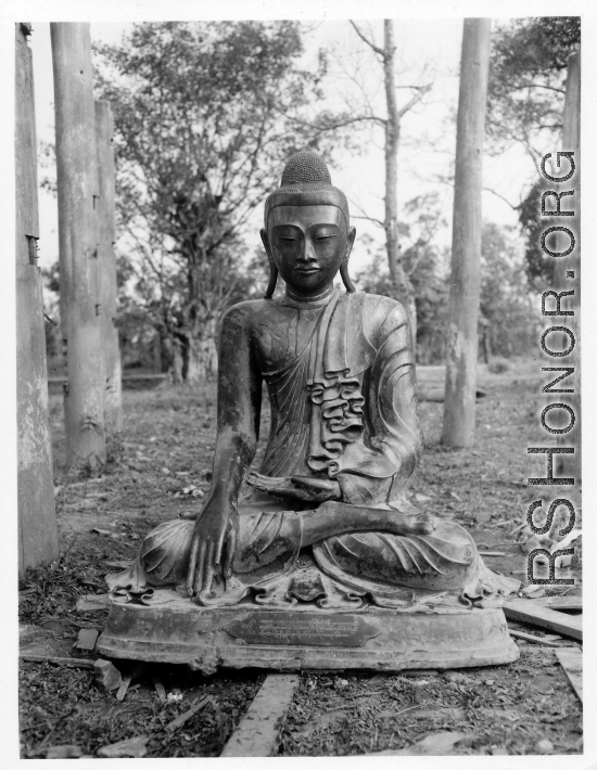 Bronze Buddha inside remains of Buddhist temple in Burma.  During WWII.