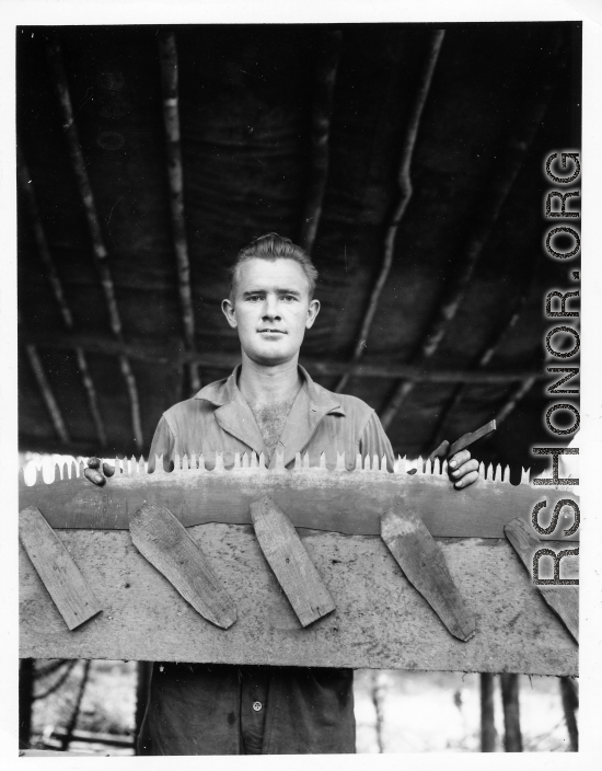 Engineer of the 797th Engineer Forestry Company in Burma, with saw in jig, being sharpened.  During WWII.