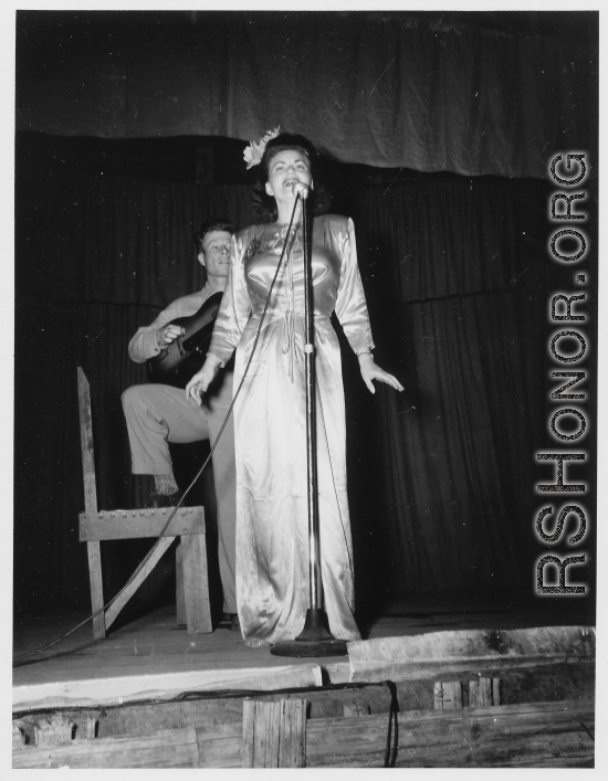 Performers well off the beaten track, providing a break for Burma Road engineers of the 797th Engineer Forestry Company--Jimmy Dodd and Ruth Carrol play guitar and sing.  During WWII.