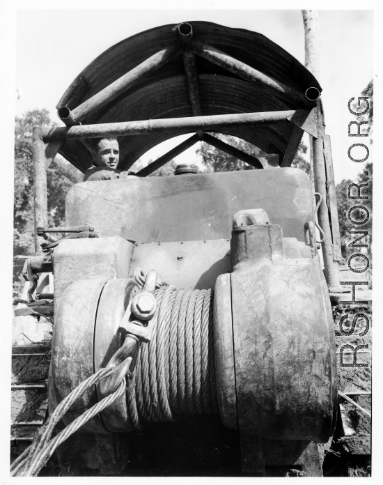 Bulldozer with cable for pulling log in Burma.  797th Engineer Forestry Company in Burma.  During WWII.
