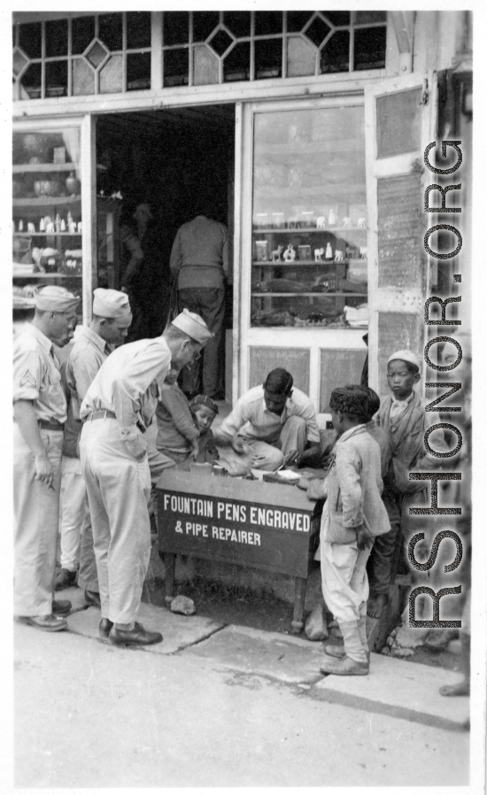 GIs of the 2005th Ordnance Maintenance Company, 28th Air Depot Group, at engraver stand, possibly in Barrackpore, India.