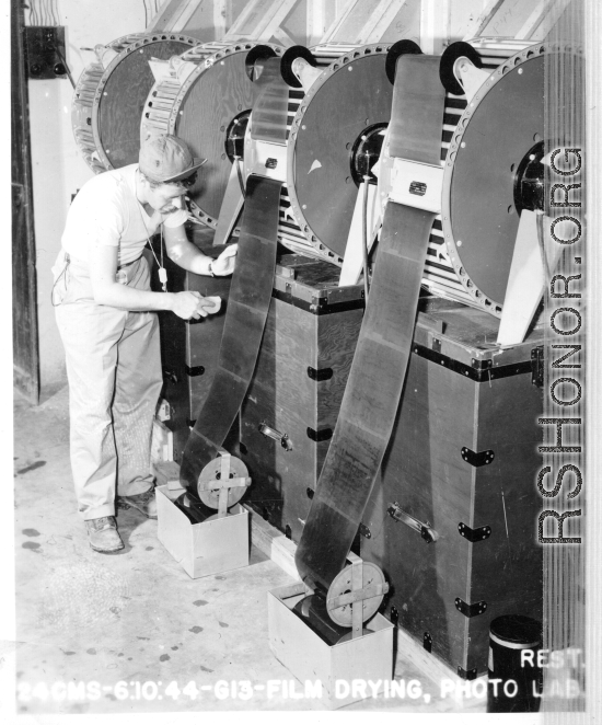 Film drying at photo lab of the 24th Mapping Squadron. June 10, 1944.