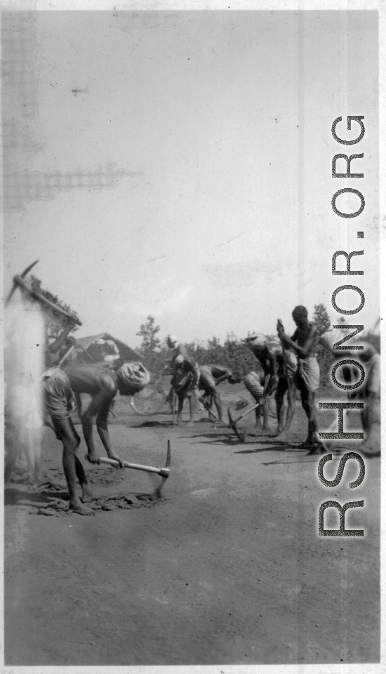 Workers dig up a well-driven surface.  Scenes in India witnessed by American GIs during WWII. For many Americans of that era, with their limited experience traveling, the everyday sights and sounds overseas were new, intriguing, and photo worthy.