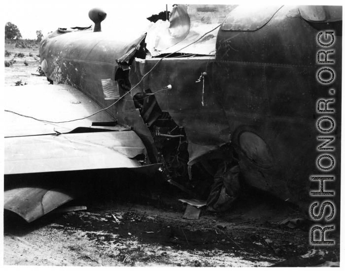 Wrecked B-25 Mitchell bomber on the ground in the CBI. The wreck was apparently at an air base, and probably on take-off, as the craft is sprayed with fire-retardant foam, and bombs are scattered about the wreck site. During WWII.