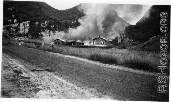 American hostels at the base burn during the American and Chinese retreat before the Japanese arrive during the Ichigo push in the fall of 1944.  Guangxi province, Liuzhou air base.