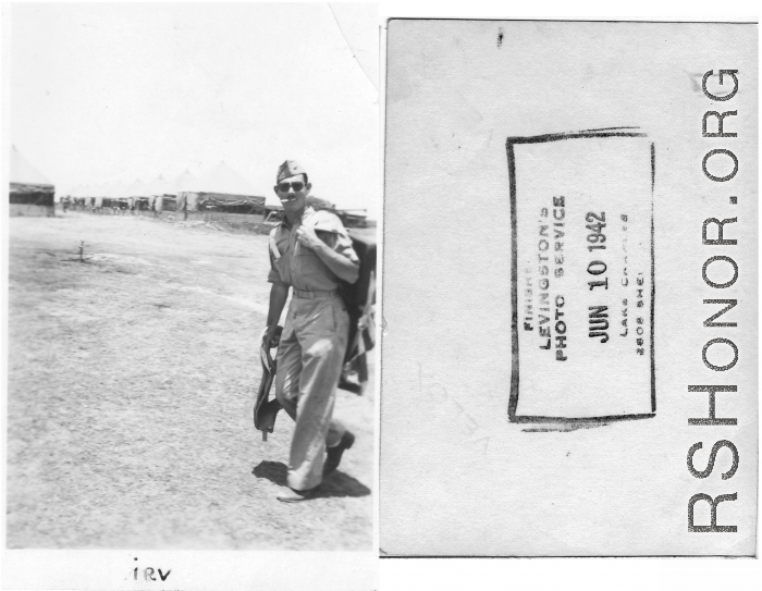 1st Lt. Irving Woodrow DeGon passes in front on tent carrying flying gear while in training.  Finished on June 1, 1942, by Levingston's Photo Service, Lake Charles, Louisiana. This is during his period of advanced training at Barksdale Field, Louisiana.