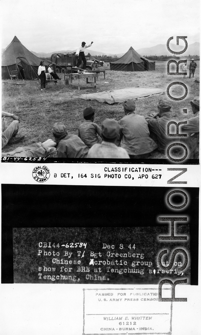 Chinese acrobatic group puts on show for Burma Road Engineers (BRE) members at the air strip, at Tengchong, China.  December 8, 1944.  Photo by T/Sgt. Greenberg. 164th Signal Photographic Company, APO 627.  Passed by William E. Whitten.