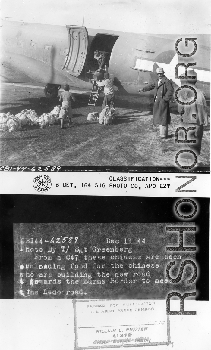 From a C-47 these Chinese are seen unloading food for the Chinese who are building the new road towards the  Burma border to meet the Ledo Road.  December 11, 1944.  Photo by T/Sgt. S. L. Greenberg. 164th Signal Photographic Company, APO 627.  Passed by William E. Whitten.