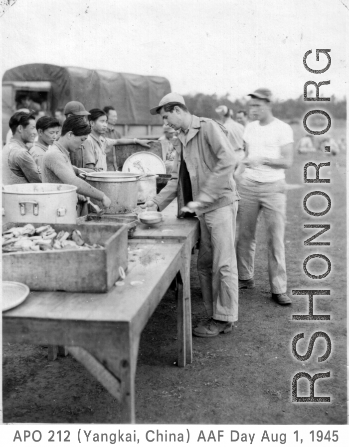 GIs line up for food distributed by Chinese staff, while enjoying AAF Day celebrations, August 1, 1945, at Yangkai, APO 212, during WWII.