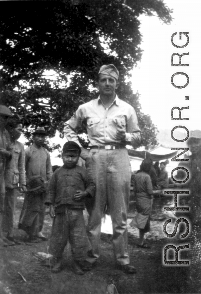 Douglas J. Runk poses with local kids and soldiers in SW China during WWII.