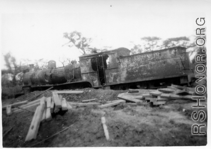 A shot up steam railroad engine, showing large number of bullet or shrapnel holes, derelict in Burma.  During WWII.  797th Engineer Forestry Company.