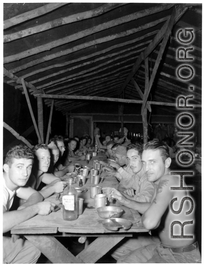 Engineers of the 797th Engineer Forestry Company eating meal at camp in Burma.  During WWII.